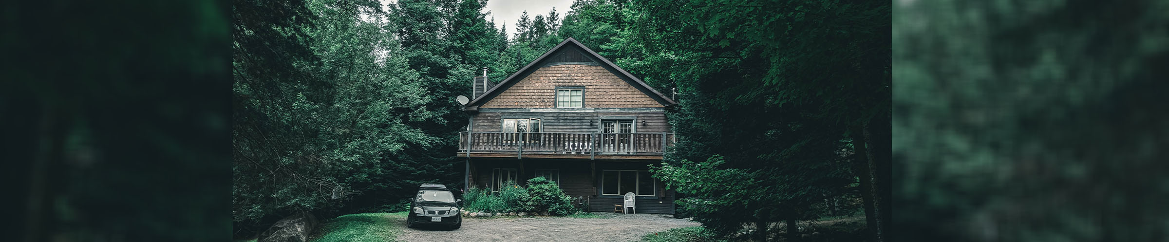 Car and cabin in the woods